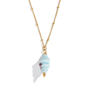 Detailed view of a gold bead chain necklace featuring a blue conch shell pendant
