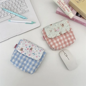 Close-up of quilted cotton mini storage bags with snap button and cute embroidery details