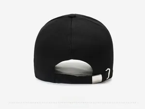 Detail view of the black baseball cap back with adjustable silver metal buckle strap