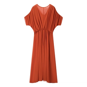 Detail of bohemian brick red maxi dress with V-neckline and flowy batwing sleeves