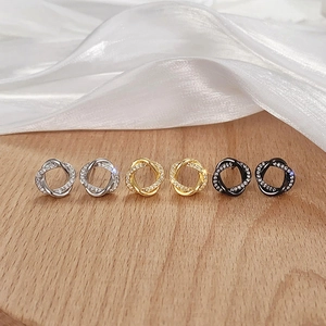 Three pairs of twisted knot stud earrings in gold, silver, and black with zircon inlay