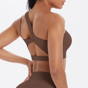 Detail of coffee brown one-shoulder sports bra with criss-cross back and high waist leggings