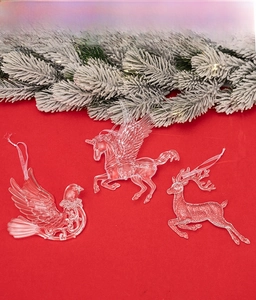 Detailed view of clear acrylic Christmas ornaments in unicorn, bird, and reindeer shapes