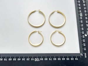 Detail view of 18K gold plated snake chain hoop earrings in 40mm and 50mm sizes