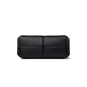 Detailed base view of black lychee grain leather bag showing precision cross stitching