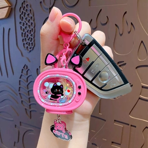 Pink cartoon television keychain with cute black cat and glitter sand held in hand