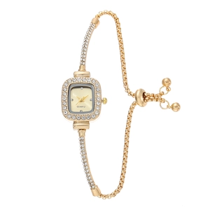 Detail of square gold watch face with crystal accents and adjustable chain strap