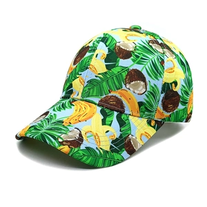 Close-up of a blue baseball cap featuring tropical banana and palm leaf print