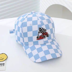 Detail of checkered baseball cap featuring racing flag embroidery and blue pattern