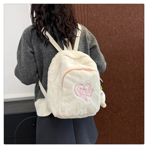 Dettaglio zaino in peluche bianco con ricamo Power Puff rosa e tasca a cuore con zip