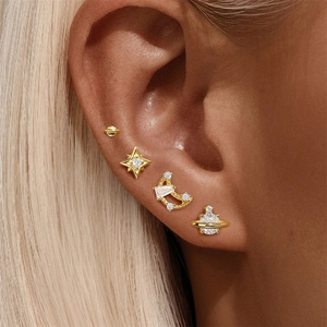 Close-up of model wearing S925 silver star moon and Saturn gold stud earring set