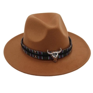 Detail of western fedora hat featuring a brown felt brim and bull head metal ornament
