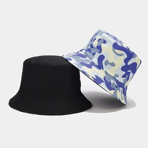 Detail view of cotton camouflage pattern and black reversible bucket hat for sun protection