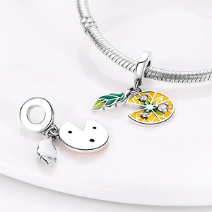 Detailed view of silver-plated lemon slices and enamel charm beads for DIY bracelets