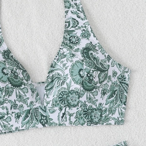 Detail of green paisley print halter bikini top with supportive wide underbust band