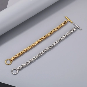 Detail of Byzantine style stainless steel dragon chains in gold and silver with OT buckle
