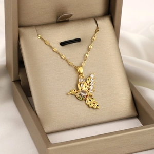Elegant gold hummingbird pendant necklace with colorful cubic zirconia in a jewelry box