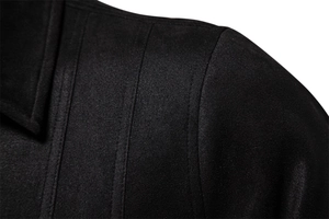 Macro view of double stitching on the shoulder of a black faux suede jacket
