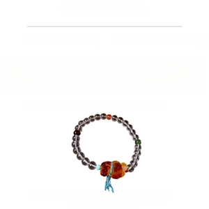 Detail view of crystal and jasper beaded bracelet with beeswax bear charm and blue cord