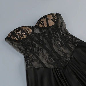 Detail of corset-style lace bodice with floral patterns and satin skirt texture