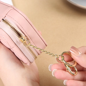 Pink heart-shaped mini makeup bag with diamond quilted pattern and golden keychain