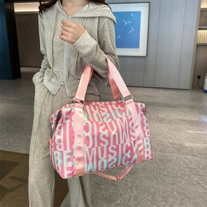 Pink large-capacity travel bag with letter patterns and shoulder strap for fitness