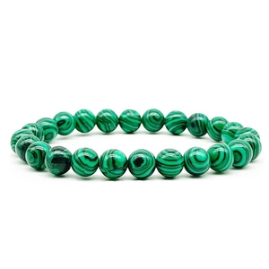 Macro detail of 8mm green malachite stone beads with natural striped texture and luster