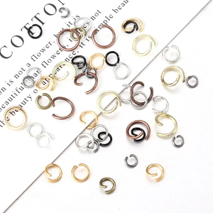 Assorted jewelry jump rings in gold, silver, and copper finishes for DIY crafts