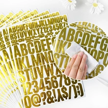 Detail showing waterproof test on golden metallic 6-inch alphabet stickers with wet cloth