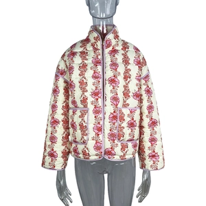 Detail of diamond quilted jacket with vintage pink floral patterns and purple piping