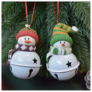 Christmas snowman bells ornaments hanging on a tree with red and green knitted hats