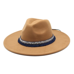 Close-up of bohemian felt fedora featuring navy ethnic braided band and blue fringe details