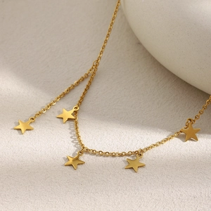 Detail of 18K gold plated stainless steel necklace featuring five pentagram star pendants