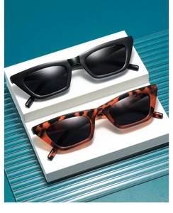 Detail shot of chic small cat-eye sunglasses in black and tortoiseshell finish
