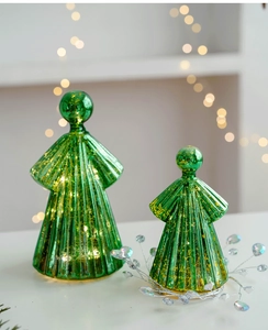Close-up of green mercury glass angel ornaments with gold speckles and warm bokeh lights