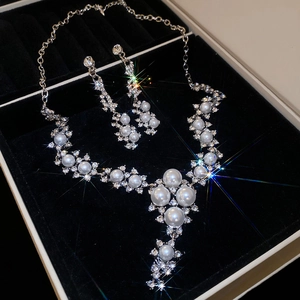 Macro shot of pearl and rhinestone necklace set in a black velvet jewelry box