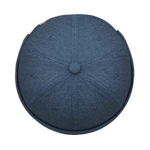 Top view of a vintage dark blue denim docker hat with six-panel stitching and vent holes