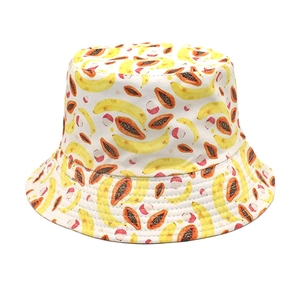 Close-up of tropical banana and papaya print on a white cotton reversible bucket hat