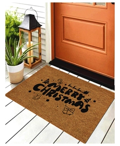 Detail of Christmas doormat with Merry Christmas text on rustic wooden porch floor