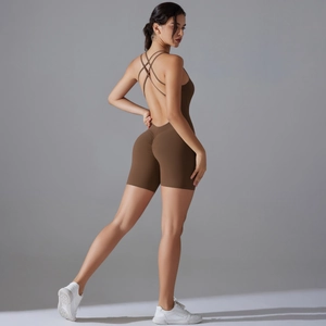 Detail of cross-back straps and shaping fabric on a brown yoga bodysuit for women