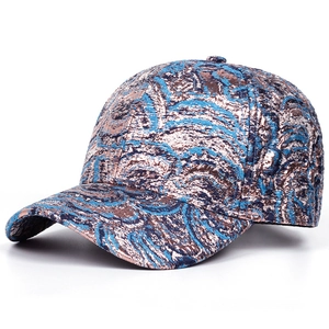 Close-up of jacquard fabric texture on a blue and bronze ethnic style baseball cap