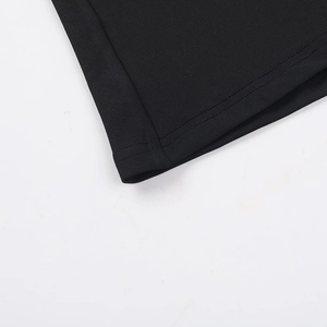 Detail view of double-needle hem stitching on black knitted long dress fabric texture