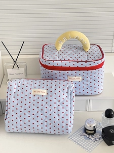 Detail of blue quilted heart makeup bag set including box case and flat pouch with handle