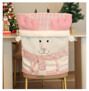 Detailed close-up of a pink reindeer chair cover with 3D antlers and sequin scarf decor
