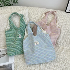 Close-up of colorful tweed tote bags with woven texture and sozakka beaute label