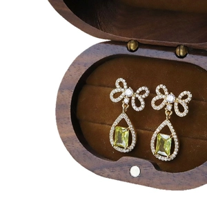 Silver needle bowknot drop earrings with yellow zircon and pavé diamonds in gold finish