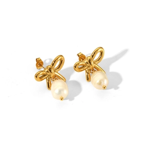Macro view of gold bow-knot earrings with pearl drop detail in stainless steel