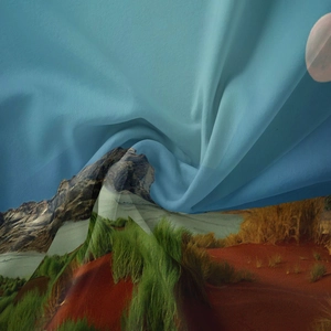 Detail of landscape tapestry fabric showing soft folds and vibrant printed mountain scenery