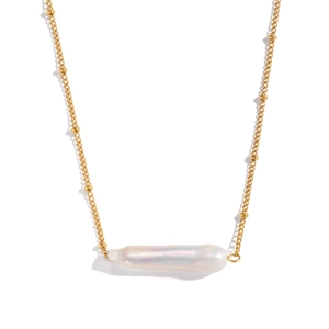 Detailed view of the golden chain necklace featuring a radiant white baroque pearl pendant