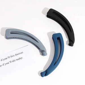 Three-piece matte banana hair clips in black, grey, and blue with ergonomic non-slip teeth
